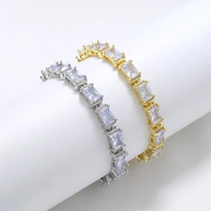 Detailed close-up of gold and silver plated hip hop bracelets with baguette cut zircons