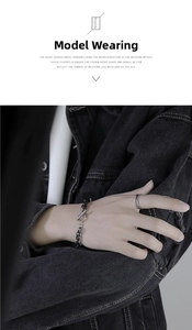 Detail of silver titanium steel chain bracelet with OT buckle and textured double ring