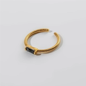 Detail of S925 sterling silver stamp on vintage twisted gold band with black zircon