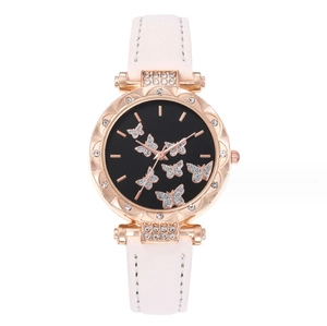 Detail of rose gold watch case with crystal bezel and butterfly motif on black dial