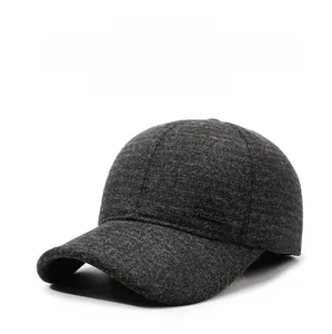 Detailed view of thick wool blend baseball cap with ear flaps and side fashion label