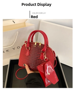 Detailed macro view of glossy red crocodile texture handbag with gold hardware