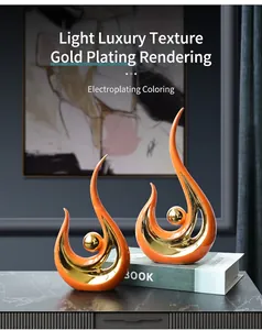 Detail of modern ceramic phoenix statues in orange and gold plating for home decor
