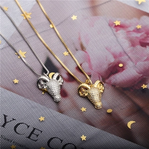 Micro-paved zircon ram head necklaces in gold and silver finish with green gem eyes