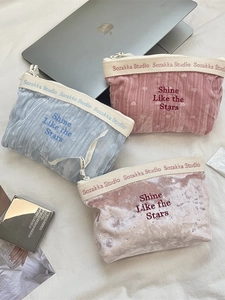 Three elegant velvet makeup bags in blue pink and champagne with star embroidery