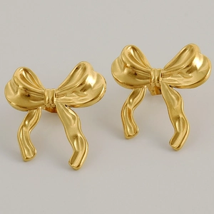 Close-up of golden ribbon bow earrings in 304 stainless steel with 18k gold plating