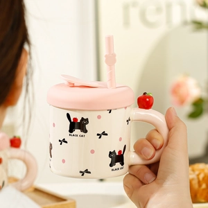 Detailed view of a pink cat ceramic mug with apple lid handle and reusable straw