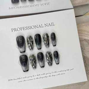 Luxurious black cat eye press-on nails with silver glitter and rhinestone accents