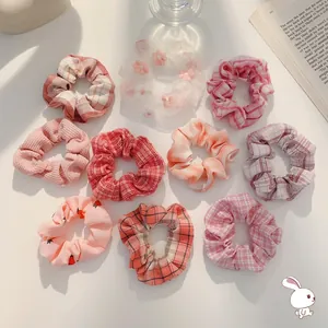 10-piece pink organza scrunchie set featuring floral embroidery and plaid patterns
