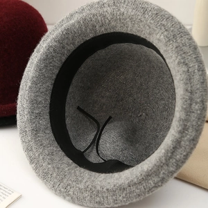 Detailed interior of gray knit bucket hat featuring black sweatband and adjustable drawstring