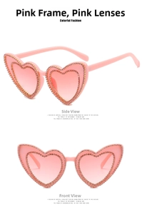 Detailed view of heart-shaped sunglasses with pink rhinestones and gradient lenses