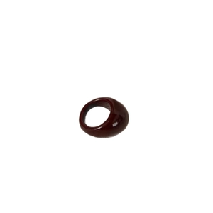Chunky dark red oval resin ring with glossy finish and irregular bold silhouette on white background