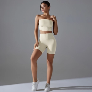 Detail view of cream-colored sports set with ribbed crop top and high-waisted gym shorts