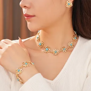 Vintage gold hollow flower jewelry set with blue stones and diamonds on model