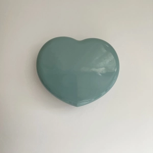 Close-up of heart-shaped storage case in Morandi blue-green with smooth glazed finish