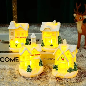 Set of 3 white resin Christmas village houses with LED glowing windows and snow details