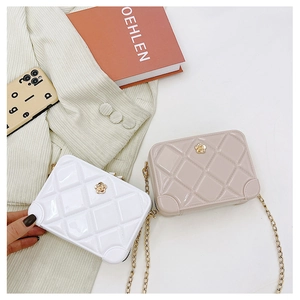 Detail of PVC jelly crossbody bags with diamond lattice pattern and gold flower accent