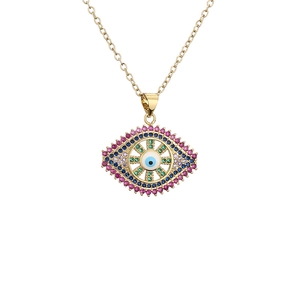Golden evil eye pendant necklace with colorful zircons and enamel center on white background