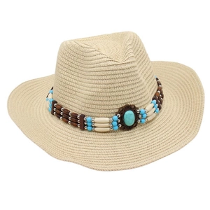 Detailed view of the turquoise stone and ethnic beaded band on a natural straw cowboy hat