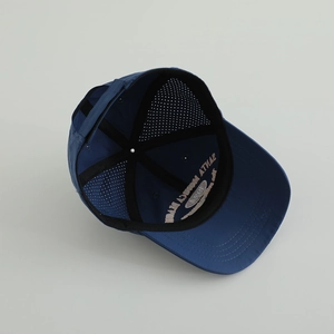 Detail of navy quick-dry kids baseball cap showing embroidery and adjustable strap