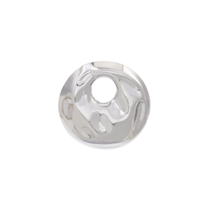 Detailed view of silver circular brooch featuring a hammered texture and cutout center