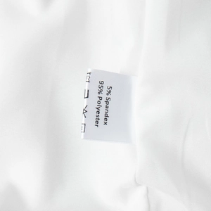 Detail of fabric care label showing 95% Polyester and 5% Spandex on white dress