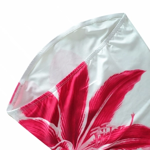 Detail shot of pink floral print on white elastic fabric with premium edge stitching