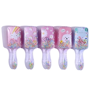 Detail of five cartoon air cushion hairbrushes with colorful beads and unicorn prints