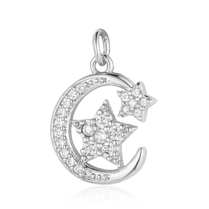 Macro shot of silver crescent moon and star pendant with clear cubic zirconia pavé
