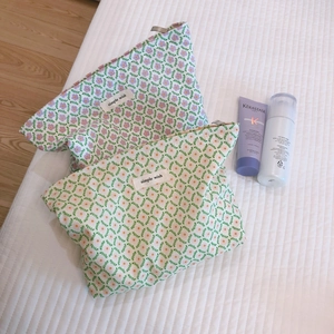 Floral print cotton makeup bags in lavender and green leaf patterns with top zippers