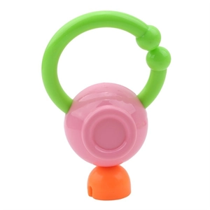 Close-up of a colorful baby rattle toy with pink sphere and green easy-to-grip handles