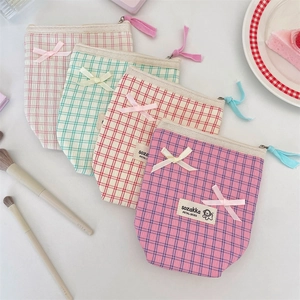 Fresh plaid cosmetic storage bags with bow detail in pastel colors for travel organizing
