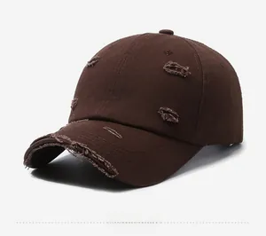 Close-up of a distressed dark brown cotton baseball cap with vintage worn-out details