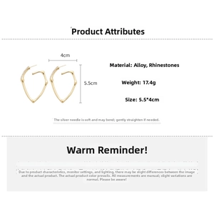 Detail view of gold heart bamboo earrings with dimensions 5.5x4cm and crystal accents