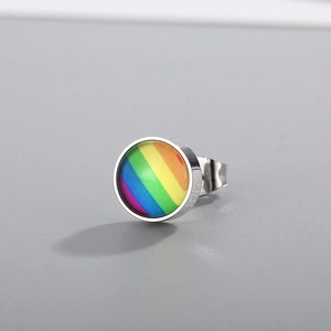 Macro view of a circular stainless steel stud earring with a vibrant rainbow pattern