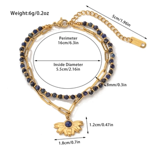 Detail of double-layer stainless steel bracelet with blue beads and sun pendant