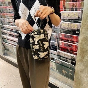 Détail d'une trousse en toile noire avec imprimé ours et lettrage Hamiets jaune