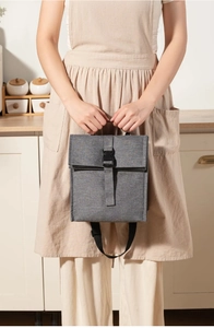Detail of insulated lunch bag showing gray linen texture and black buckle closure