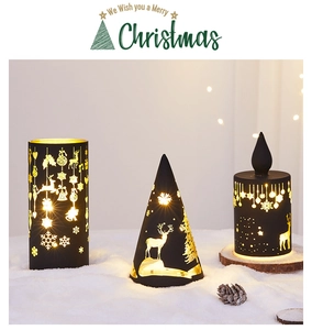 Detail of Christmas reindeer and snowflake hollow patterns on black cone glass lamps