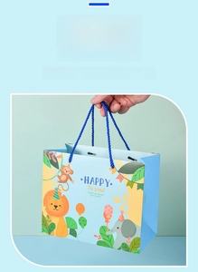 Close-up of cute cartoon animal forest illustrations and blue handle on paper gift bag