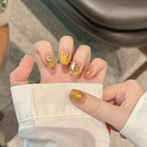 Luxury gold cat-eye press-on nails with 3D floral accents and sparkling crystals