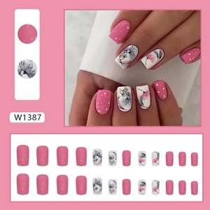 Pink matte floral press-on nails with glitter accents and elegant ink flower patterns