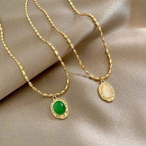 Retro cat eye stone pendant necklaces with vintage gold relief frames on satin