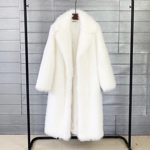 Detail of white faux fur coat featuring thick plush texture and large notched lapels