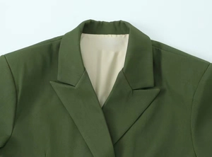Dettaglio del risvolto e delle cuciture di un blazer oversize verde scuro da donna