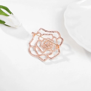 Elegant rose gold hollow rose brooch with multi-layered metal petals on white background