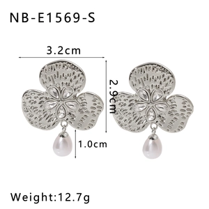 Detail of vintage flower earrings with sparkling cubic zirconia and white pearls