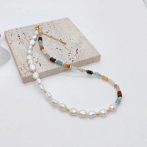 Detailed close-up of Baroque pearl and amazonite beaded necklace with gold accents