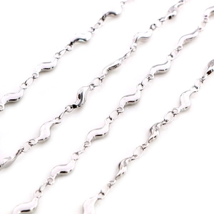 Macro detail of polished silver stainless steel wave-shaped chain links for jewelry making