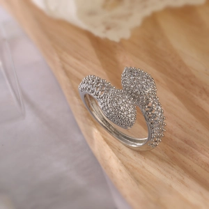 Silver open snake ring with pave heart motifs and zircons shown from a professional angle